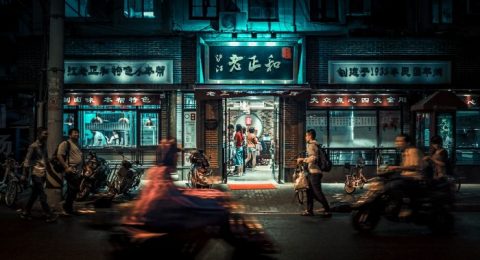 motorcycles and people passing by at night time